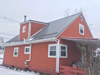 an orange house with a metal roof